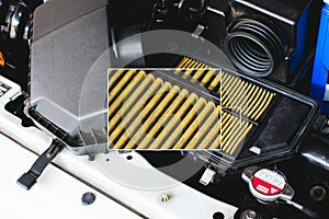 A close up of an automobile air filter is displayed in a frame