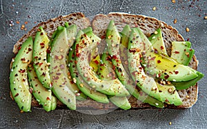 A close-up of avocado toast seasoned with red pepper flakes and sesame seeds, a delicious and healthful delight. The