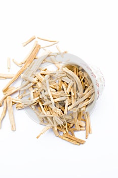 Close up of Ayurvedic herb Satavari or kurilo or Asparagus racemosus isolated on white in a glass bowl.