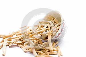 Close up of Ayurvedic herb Satavari or kurilo or Asparagus racemosus on white in a glass bowl.