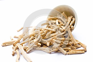 Close up of Ayurvedic herb Satavari or kurilo or Asparagus racemosus on white in a glass bowl.