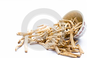 Close up of Ayurvedic herb Satavari or kurilo or Asparagus racemosus on white in a glass bowl.