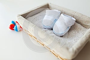 Close up of baby bootees for newborn boy in basket