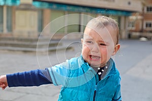 Close-up of baby boy crying on the street