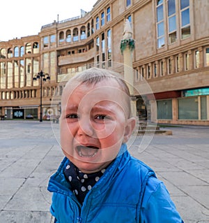 Close-up of baby boy crying on the street