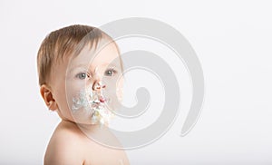 Close Up of Baby with Face Full of Cake and Frosting