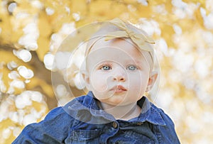 Close Up on Baby Girl with Bow on Head and Huge Blue Eyes