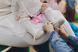 Close up of baby girl& x27;s hands trying to lace shoes by herself.