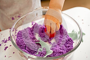 Close up of baby hand playing with kinetic sand