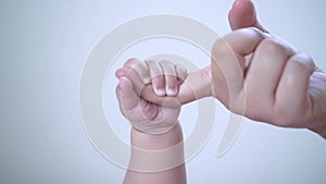 Close up of Baby holding mother`s finger | Footage of Newborn Baby Playing With Mother`s Hand and Finger