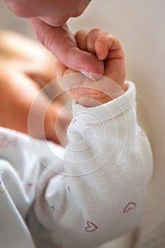 Close Up Of Baby Holding Parents Finger