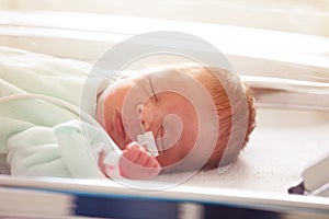 Close-up of a baby in ICU with nose tube feeding