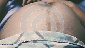 Close up baby movements during pregnancy. Baby moving inside mother`s womb. Vintage tone.