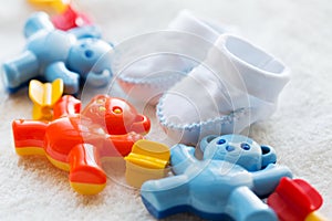 Close up of baby rattle and bootees for newborn