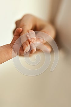 Close-up of baby& x27;s hand holding mother& x27;s finger