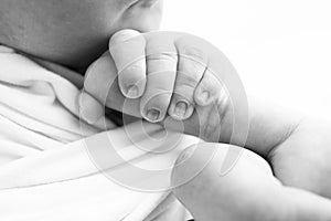 Close-up of baby& x27;s small hand, head, ear and palm of mother.