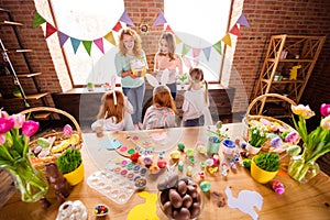 Close up back behind rear photo three children make decorate eggs easter children day glad two mom bring gift boxes