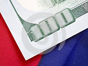 Close up, back side of American one hundred dollar bill on USA flag background.