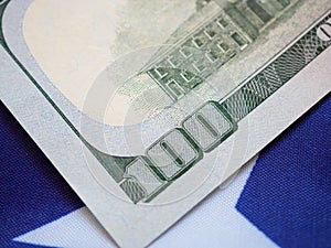 Close up, back side of American one hundred dollar bill on USA flag background.