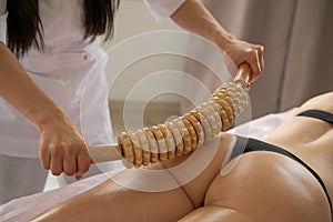 Close-up on back unidentified woman having anti-cellulite massage session photo