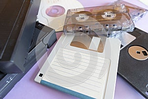 Close-up, background depicting elements of the 1990s.Coloured cardboard creating triangular shapes and electronic storage devices