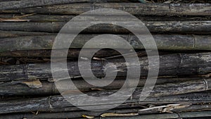 Black Background of dry thick bamboo poles.