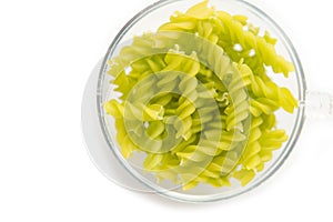 Close-up background of Fusille and Rotini in a glass bowl on white. pasta