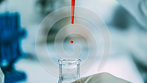 Close up. background image of a drop of red liquid in a laboratory pipette.