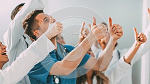 close up. background image of a group of doctors showing thumbs