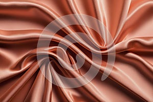 Close-up background with wavy texture of satin fabric color Peach Fuz photo