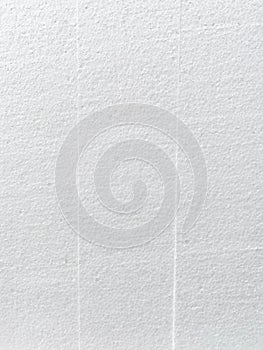 Close-up of the background of the white polystyrene foam structure with vertical stripes