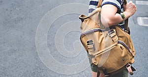 Close up backpack at back of woman traveler walking on street to