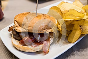 Close up bacon cheese burger with potato chips