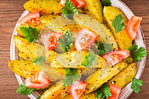 Close up of baked potatoes in a peel with tomatoes