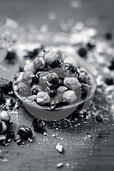 Close up of baked or roasted chickpea/channa or dalia in a bowl on a blue surface.