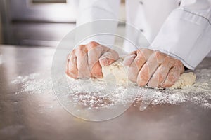 Close up of baker preparing dough