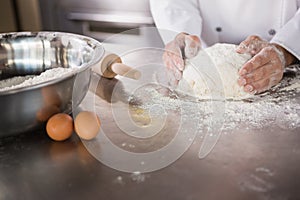 Close up of baker preparing dough