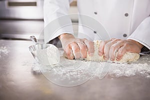 Close up of baker preparing dough