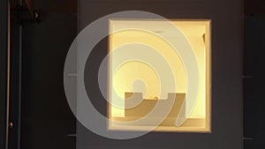 Close up of baking artificial teeth in extremely high temperature oven in dental laboratory. Dental technician bakes ceramic teeth