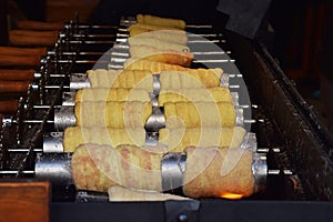 Close up baking chimney cake on grill