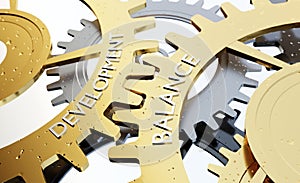 Close up balance with development text on gold cogwheel scene