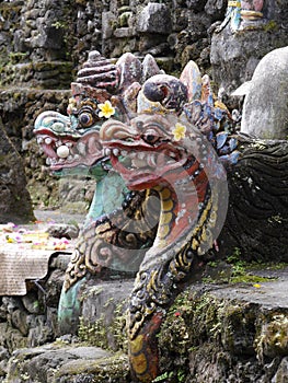 Close up of Balinese dragon god statues in Pura Sangara sea temple near Sanur, Bali