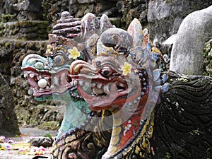 Close up of Balinese dragon gods with egg in mouth at Pura Sangara sea temple near Sanur, Bali, Indonesia