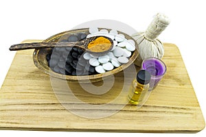 Close up ball compressing spa and black and white stone with aroma candle present in Yin - Yang spa concept isolate on white