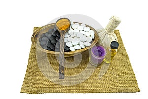 Close up ball compressing spa and black and white stone with aroma candle present in Yin - Yang spa concept isolate on white