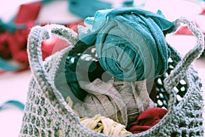 Close up ball of yarn in bag from recycle old t shirt on white background