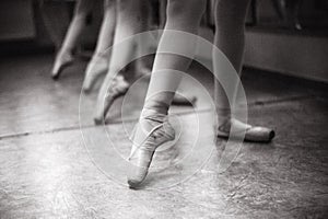 Close-up of ballerina feet on pointe shoes in the dance hall. V