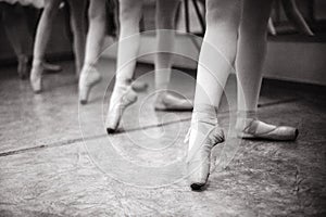 Close-up of ballerina feet on pointe shoes in the dance hall. V