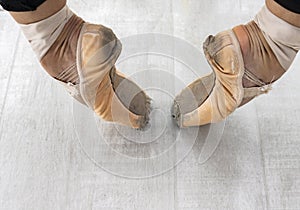 Close up of ballerina`s leg, she is standing on stair outside wearing