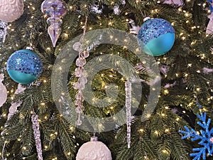 Close up of balls on christmas tree. Bokeh garlands in the background. New Year concept.